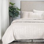 Amity home emery quilt in opal   vertical channel stitched