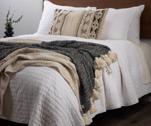 Amity home white base camp quilt with a soft crinkled quilted texture draped on a luxury bed