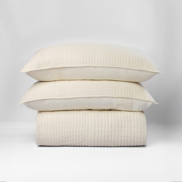 Amity Home Catalina Linen Quilt - Ivory linen quilt with subtle linear texture, stacked with two matching shams.