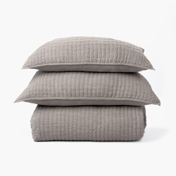 Amity Home Catalina Linen Quilt - Grey chambray linen quilt and two matching pillows with a subtle quilted texture, stacked.