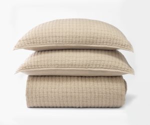 Amity home catalina linen quilt in natural with subtle diamond quilting stacked with two matching shams