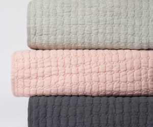 Amity home catalina linen quilt   petal pink linen quilt with diamond quilting texture stacked with sage and charcoal quilts