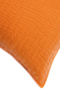 Amity home ethan quilt   close up of soft papaya orange fabric with subtle diamond quilting and plush texture