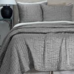 Amity home hadon quilt   grey textured quilt with a unique ruched pattern styled on a bed with matching pillows