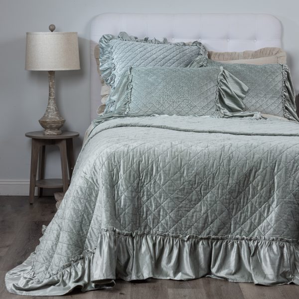 Amity Home Estrella Quilt - Sea Glass crushed velvet quilt with diamond quilting and ruffled edges on a styled bed.