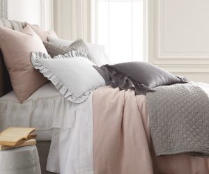 Amity home damara duvet cover   petal pink duvet cover draped on a luxurious bed with layered pillows and a grey quilt