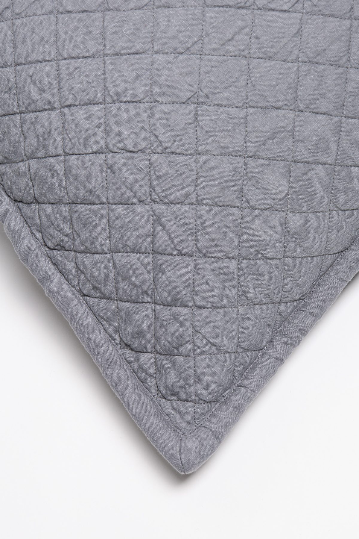 Amity home dale linen quilt   close up of neutral grey linen fabric with square quilting and crinkled texture