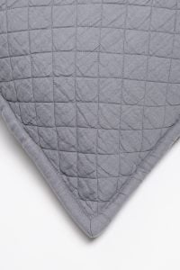 Amity home dale linen quilt   close up of neutral grey linen fabric with square quilting and crinkled texture