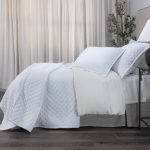 Amity home dale linen quilt in white featuring a subtle diamond quilting pattern draped on a styled bed with matching shams
