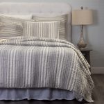 Amity home aiden quilt   grey and cream striped textured quilt and shams on a bed with a white headboard