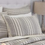 Amity home aiden quilt   grey and cream striped quilted bedding set on a bed with matching pillow shams