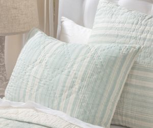 Amity home aiden quilt in seaglass and cream stripes with a soft quilted texture styled on a bed