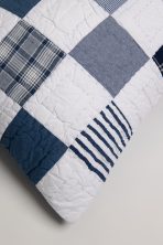 Amity home jesse quilt   patchwork design in white navy and denim blue with plaid striped and solid squares featuring visible hand quilting stitches