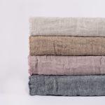 Amity home kent bedspread in ochrenatural   stacked linen swatches with frayed edges