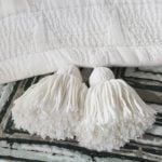 Amity home zion quilt in ivory   chunky tassel detail