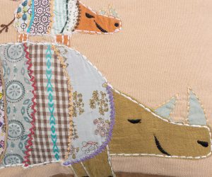 Amity home rhino pillow in multi color patchwork   appliqué rhinos design
