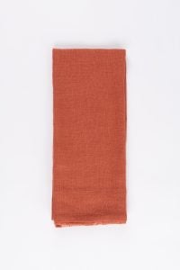 Amity home ranier linen guest towel set in burnt sienna   folded with raw edge