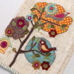 Amity home eara throw in cream   detailed bird  tree appliqué