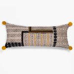 Amity home bina x long bolster in beigeblackyellow   geometric pattern with pom poms