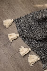 Amity home zenith throw in charcoal marled   cream tassels