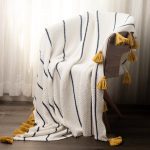 Amity home wilson throw in cream navy  mustard   striped knit with tassels