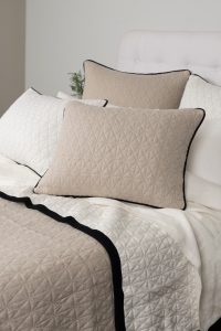 Amity home kirk knitted quilt in natural   geometric quilted with black trim