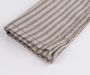 Amity home bernadette napkin in walnut brown stripe   stitched linen texture