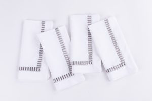 Amity home savona dinner napkin set in white with grey embroidery   elegant border design