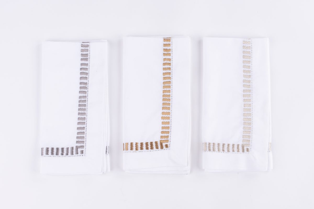 Amity home savona dinner napkin set set of 4 in white with grey embroidery   ladder stitch border