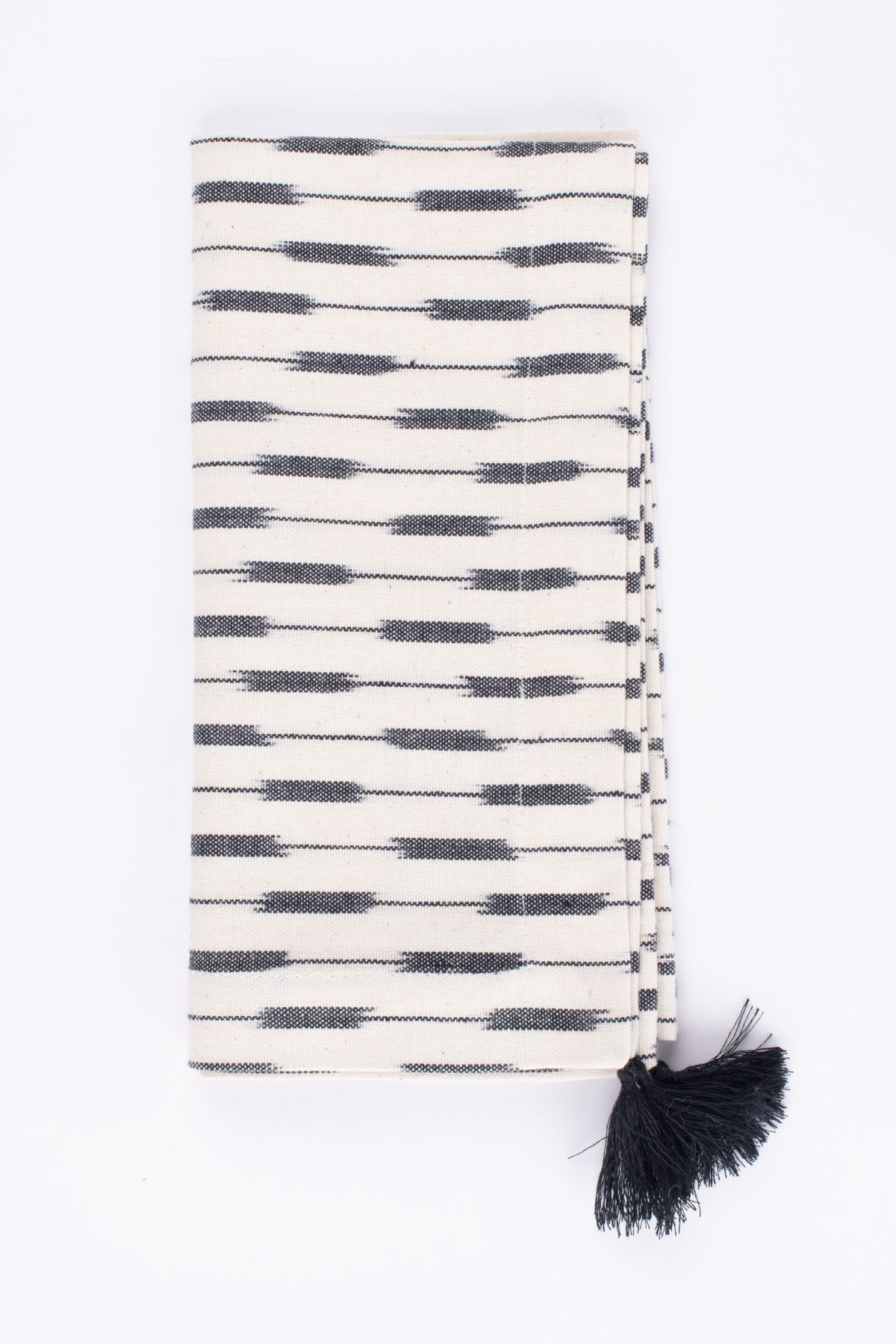 Amity home lana dinner napkin set in cream  black ikat   tassel detail