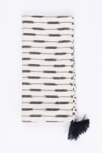 Amity home lana dinner napkin set in cream  black ikat   tassel detail