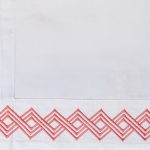 Amity home amalfi sheet swatch in coral  white   geometric embroidery