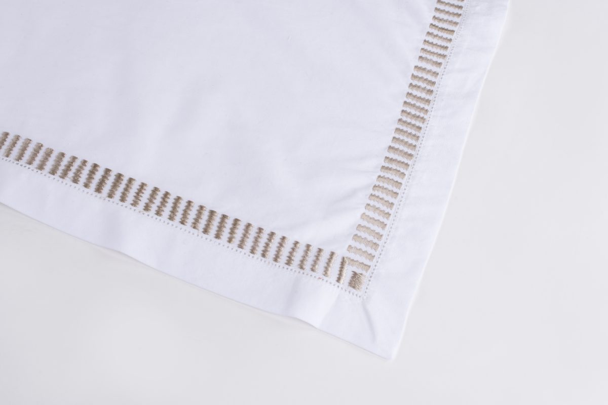 Amity home savona table runner in oyster   embroidered ladder stitch border