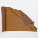 Amity home spencer table runner in ochre   hand stitched grid pattern