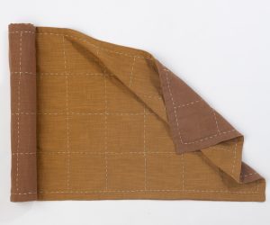 Amity home spencer table runner in ochre   hand stitched grid pattern