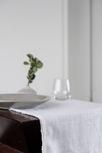 Amity home ranier linen table runner in ivory   raw edge detail