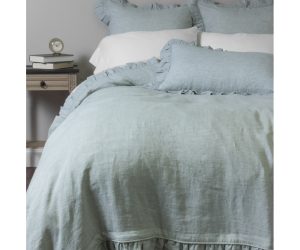 Amity home basillo duvet cover   sea glass linen with ruffled edges styled on a bed with matching shams