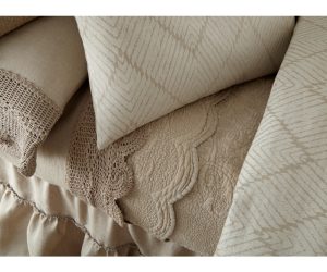 Amity home bastien trupunto linen quilt   natural beige featuring a scalloped edge and intricate trupunto quilting