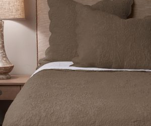 Amity home bastien trupunto linen quilt   walnut brown quilt with intricate raised quilted texture styled on a bed with matching shams