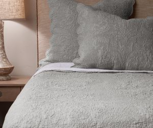 Amity home bastien trupunto linen quilt in grey chambray featuring a textured quilted pattern styled on a bed with matching shams