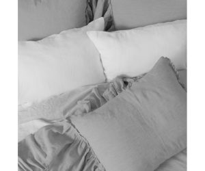 Amity home caprice duvet cover   platinum grey linen bedding with ruffled edges and layered white pillows on a styled bed