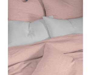 Amity home damara duvet cover   petal pink textured linen bedding styled on a bed with matching shams and white pillows