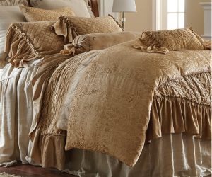 Amity home estrella quilt   caramel paisley quilt on a bed with diamond quilted layers ruffled pillows and elegant bedding