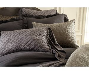 Amity home estrella quilt   steel blue diamond quilted bedding with ruffled accents on a luxurious styled bed