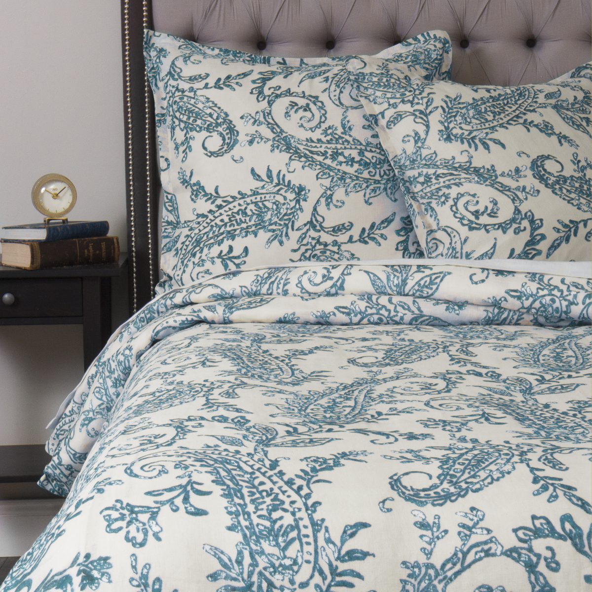 Amity home kiera duvet cover   turquoise paisley pattern on cream luxury bedding styled on a bed with a tufted headboard