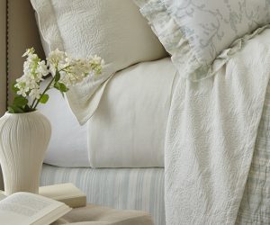 Amity home luxx modal sheet set in ivory showing smooth soft fabric on a styled bed with decorative pillows