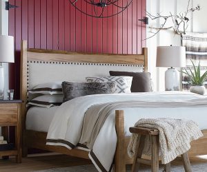 Amity home orfeo linen duvet cover   ivory linen duvet with brown trim styled on a rustic bed with layered pillows