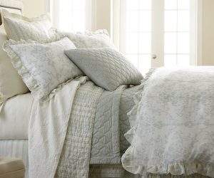 Amity home riva duvet cover   seaglass and white with delicate floral pattern ruffled edge on a layered luxury bed