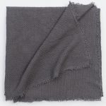 Amity home tipton matelasse in charcoal   woven texture with frayed edges